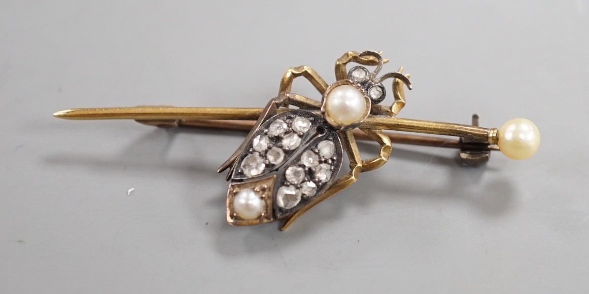 An early 20th century white and yellow metal, rose cut diamond and split pearl cluster set bug bar brooch, 49mm, gross weight 4.6 grams.